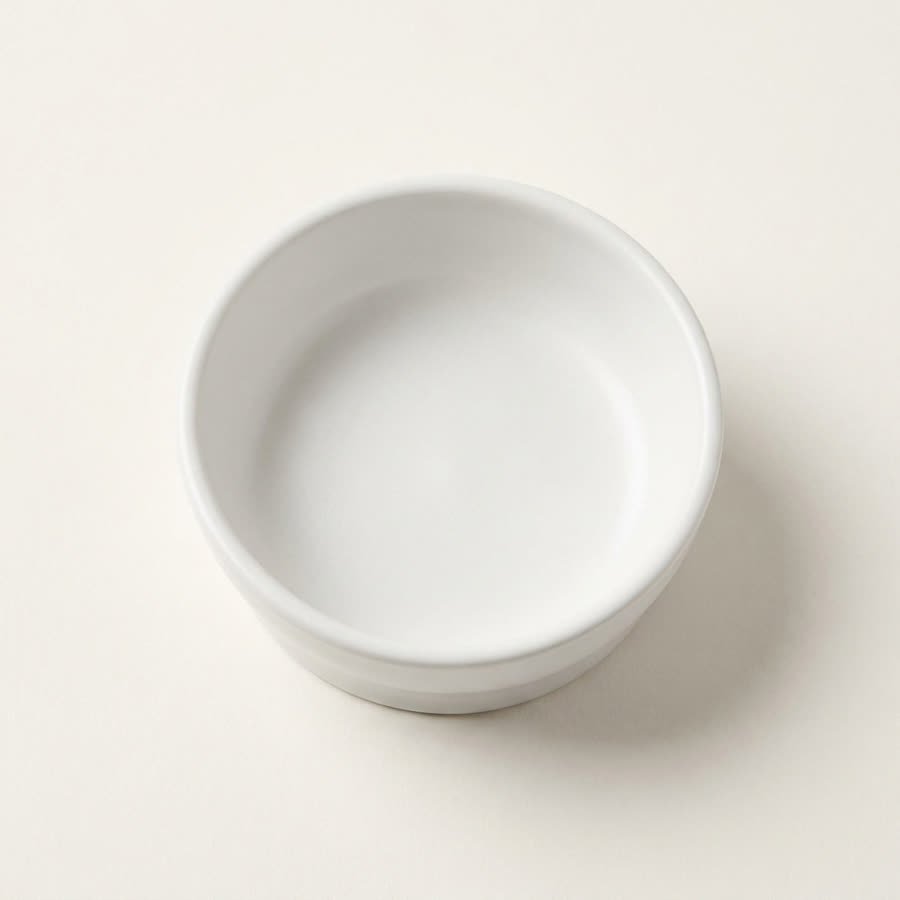 A single white prep bowl photographed from directly above